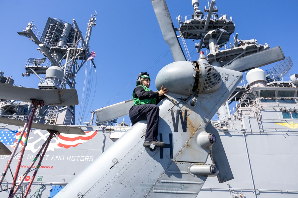 Sailor Conducts Maintenance on an MH-60S Seahawk Helicopter onboard USS Iwo Jima