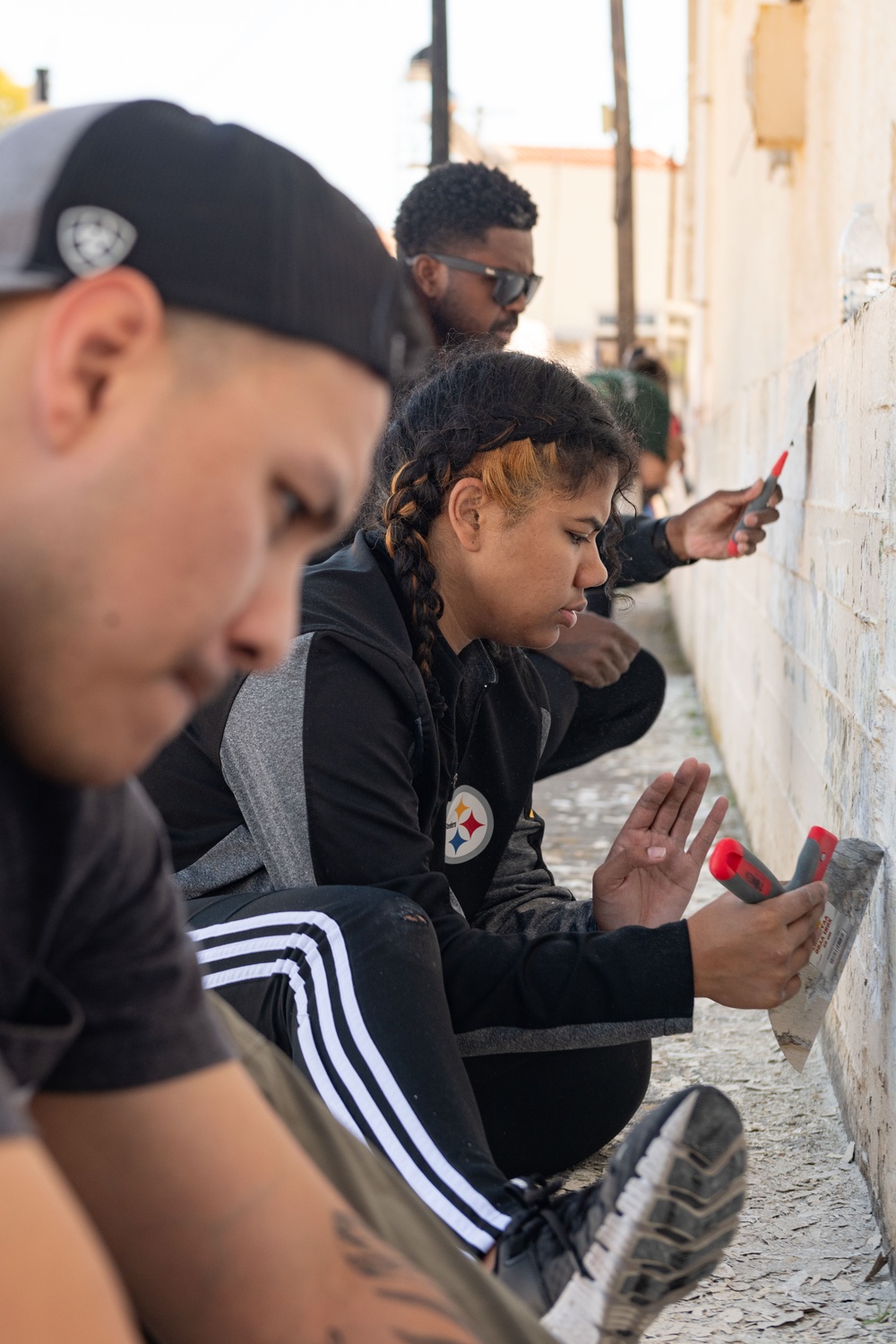 Team Souda paints a local elementary school during a community outreach event