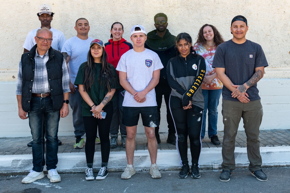 Team Souda paints a local elementary school during a community outreach event