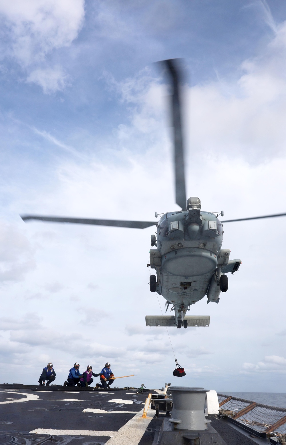 USS Gravely conducts a helicopter in-flight refueling evolution