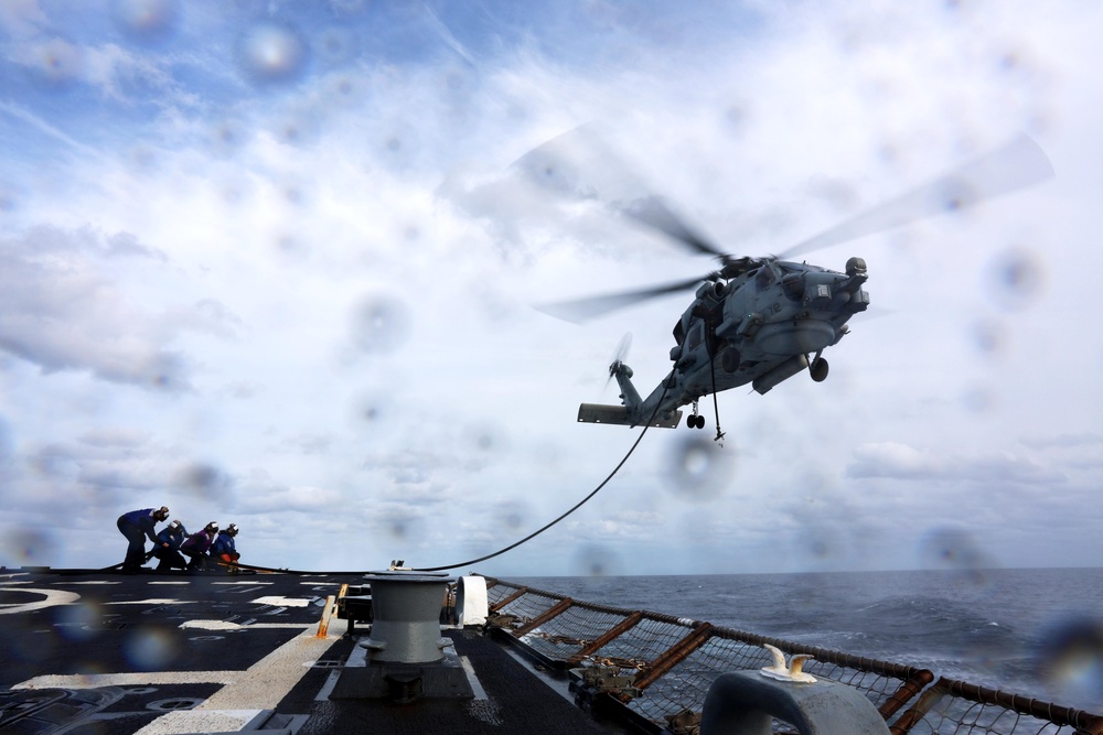 USS Gravely conducts a helicopter in-flight refueling evolution
