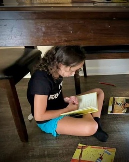 DoDEA Elementary students are turning pages under tables during Reading Bingo