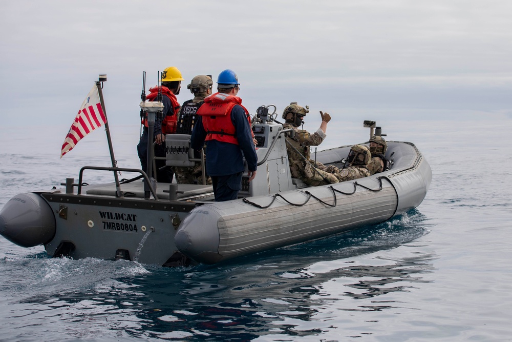 U.S. Coast Guard conducts small boat operations with USS Spruance