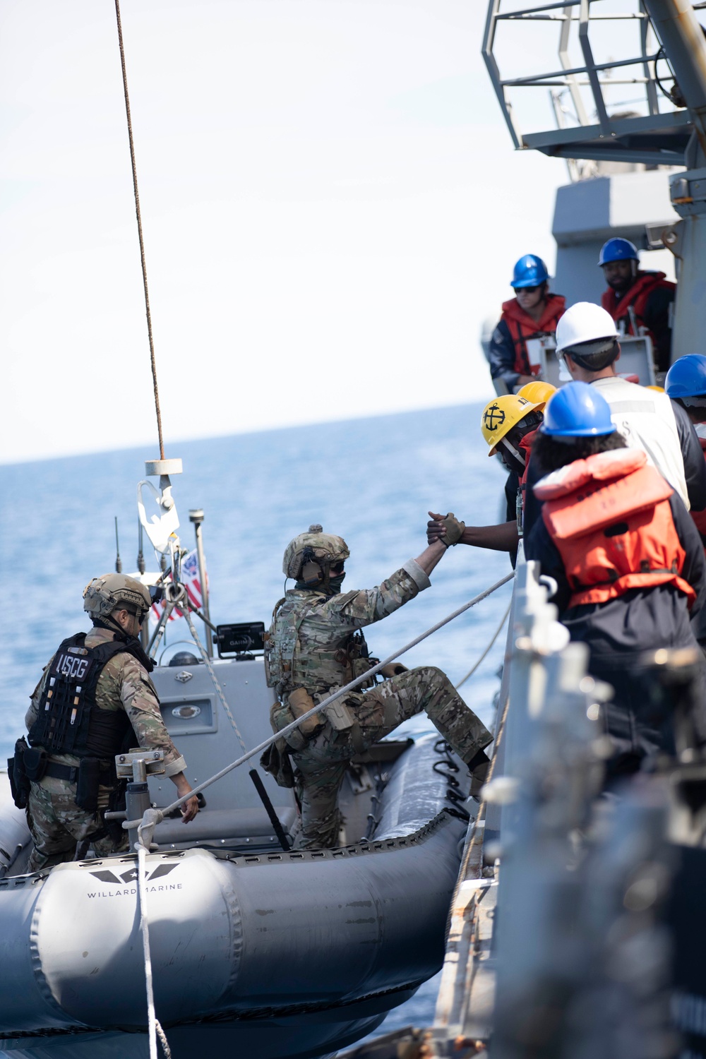 U.S. Coast Guard conducts small boat operations with U.S. Navy Sailors