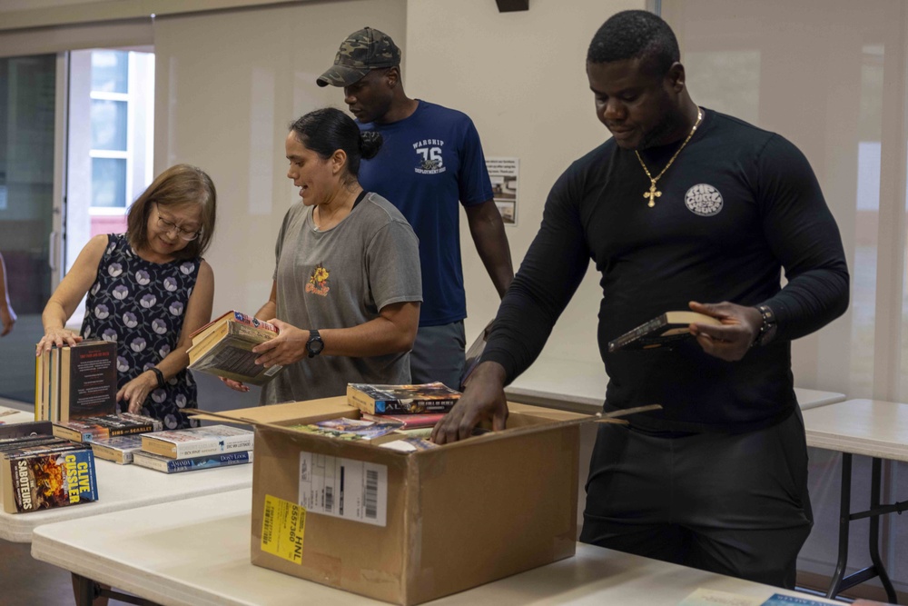 Navy Volunteers Help Aiea Public Library Organize Books for Annual Book Sale