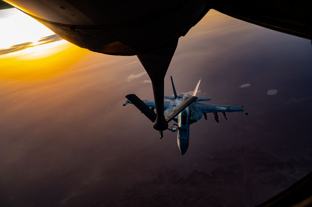 CENTCOM KC-135 Stratotanker conducts nighttime aerial refueling with F/A-18 Super Hornets