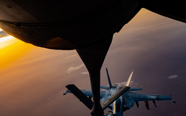 CENTCOM KC-135 Stratotanker conducts nighttime aerial refueling with F/A-18 Super Hornets