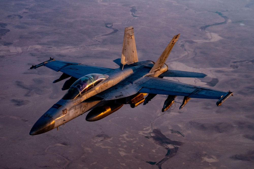 CENTCOM KC-135 Stratotanker conducts nighttime aerial refueling with F/A-18 Super Hornets