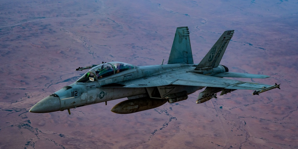 CENTCOM KC-135 Stratotanker conducts nighttime aerial refueling with F/A-18 Super Hornets