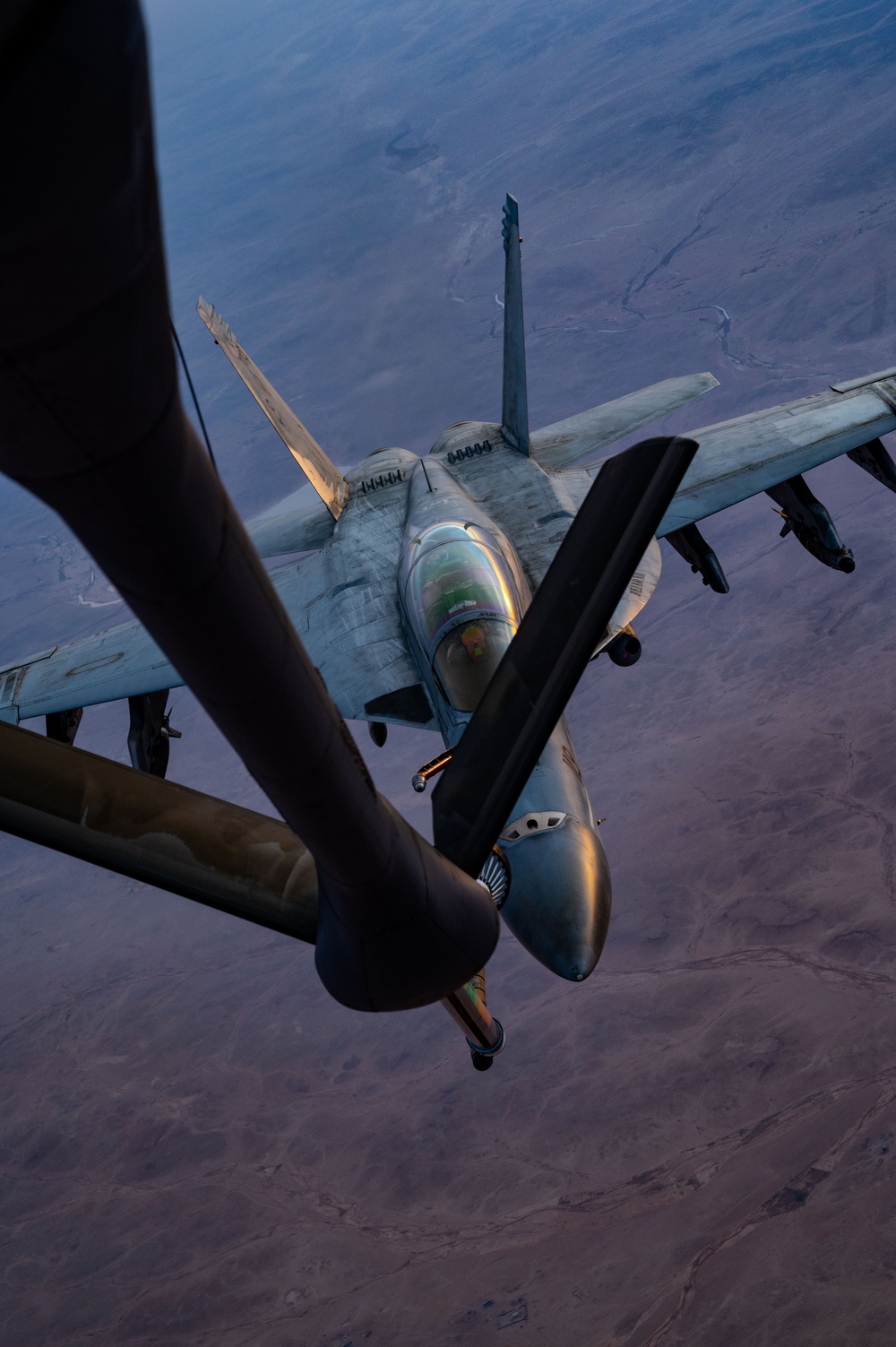 CENTCOM KC-135 Stratotanker conducts nighttime aerial refueling with F/A-18 Super Hornets