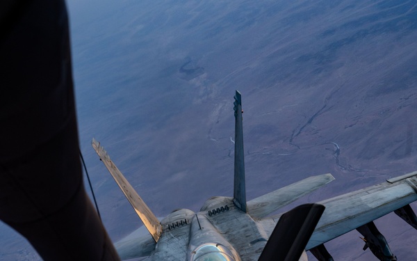 CENTCOM KC-135 Stratotanker conducts nighttime aerial refueling with F/A-18 Super Hornets