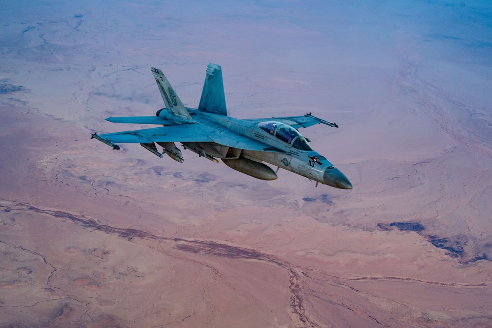 CENTCOM KC-135 Stratotanker conducts nighttime aerial refueling with F/A-18 Super Hornets