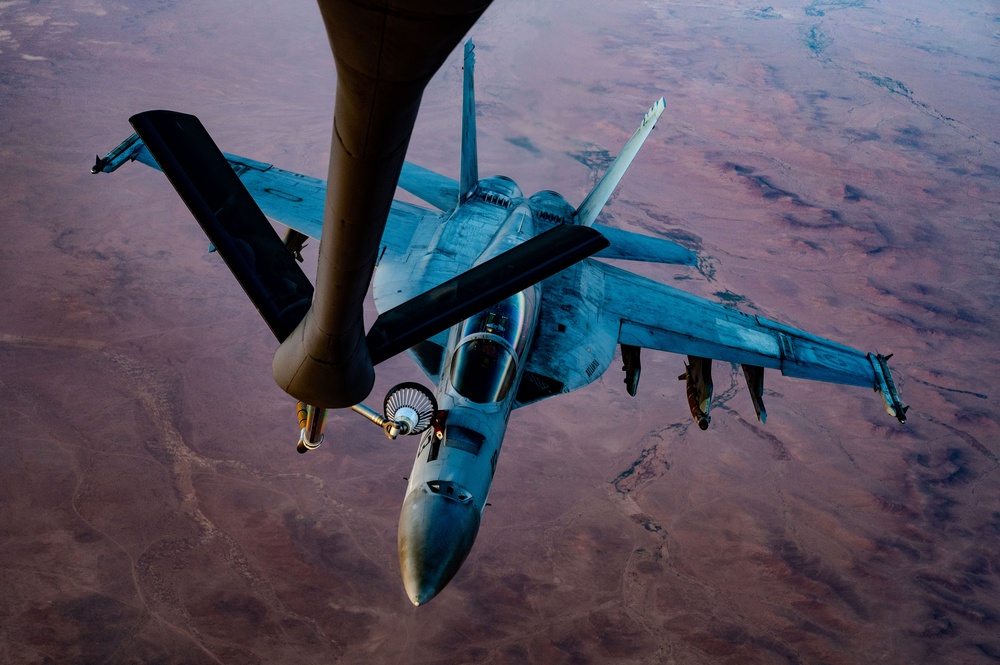 CENTCOM KC-135 Stratotanker conducts nighttime aerial refueling with F/A-18 Super Hornets