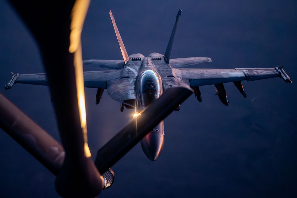 CENTCOM KC-135 Stratotanker conducts nighttime aerial refueling with F/A-18 Super Hornets