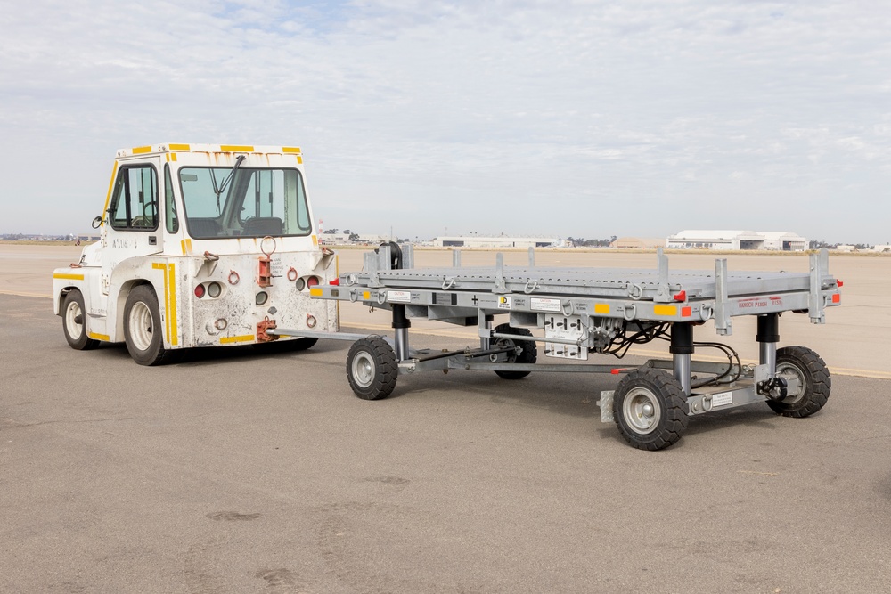 MAG-11 Marines load weapons and equipment using Marine adjustable cargo trailer