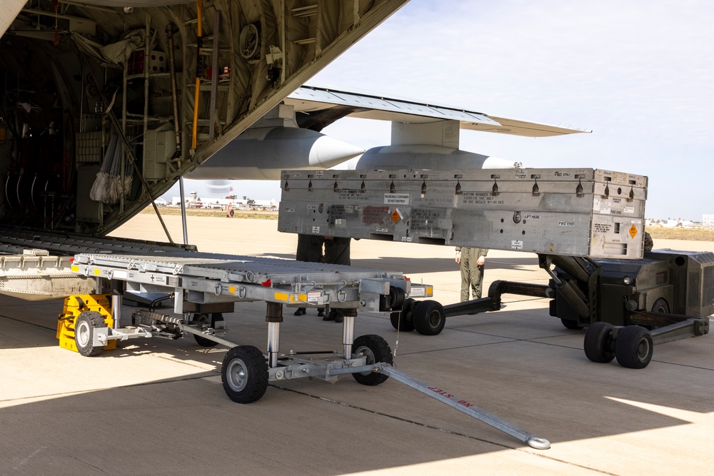 MAG-11 Marines load weapons and equipment using Marine adjustable cargo trailer