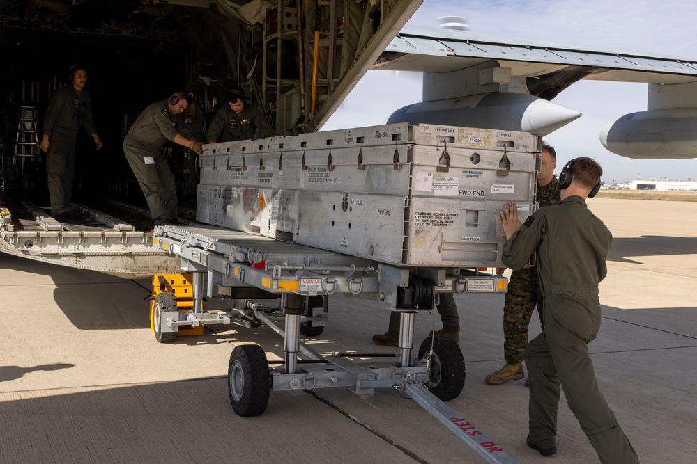 MAG-11 Marines load weapons and equipment using Marine adjustable cargo trailer