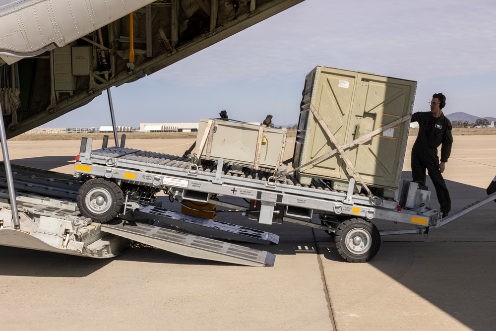 MAG-11 Marines load weapons and equipment using Marine adjustable cargo trailer