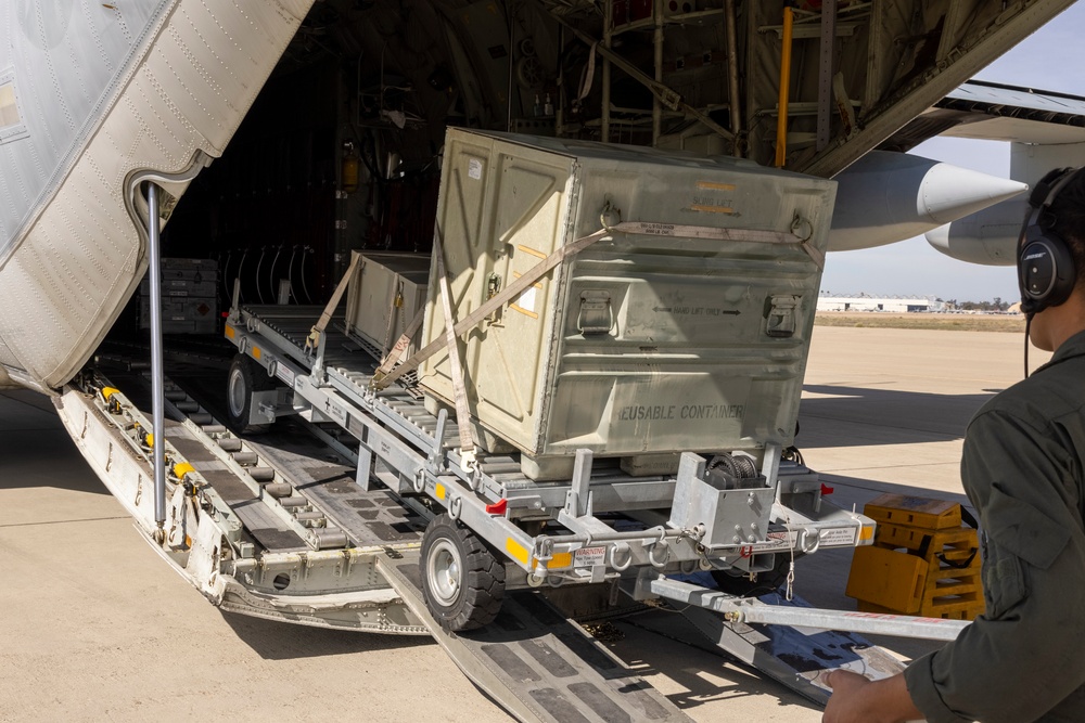 MAG-11 Marines load weapons and equipment using Marine adjustable cargo trailer