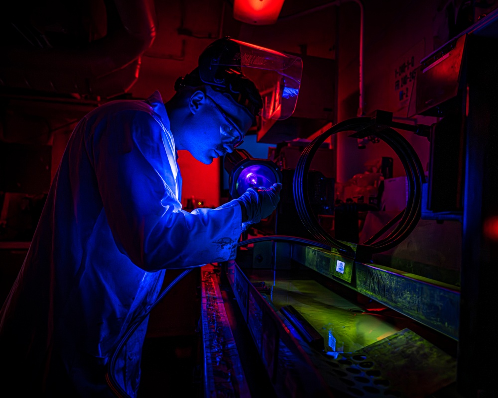 Nimitz Sailor Utilizes a Magnetic Particle Bench to Test Parts