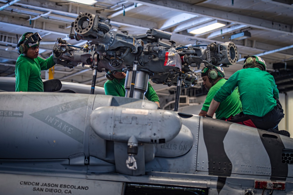Nimitz Sailors Perform Maintenance on an MH-60R Sea Hawk Helicopter