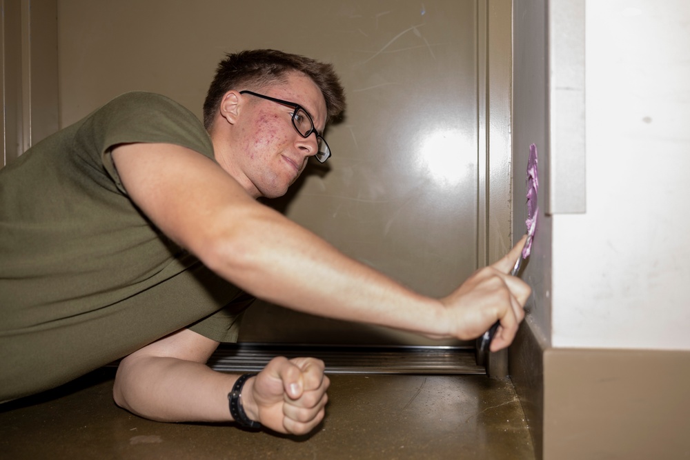 Marines repair barracks walls as part of Operation Clean Sweep-II