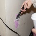 Marines repair barracks walls as part of Operation Clean Sweep-II