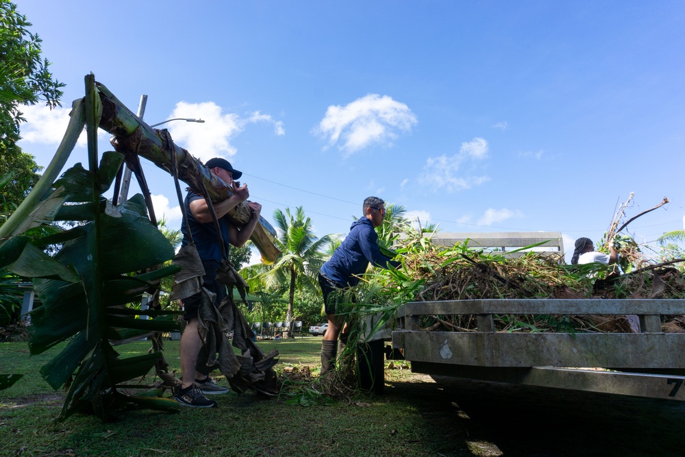 CLC 34 Marines and MCB Camp Blaz Marines work with community members to clean-up a village of Piti Park.
