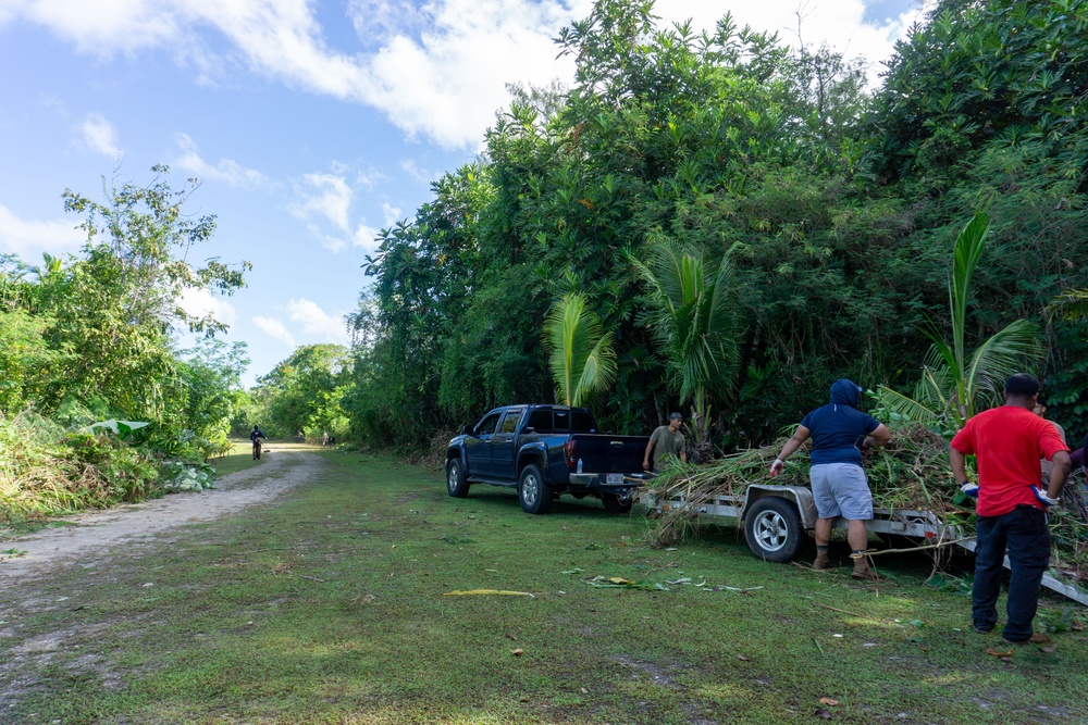 CLC 34 Marines and MCB Camp Blaz Marines work with community members to clean-up a village of Piti Park.