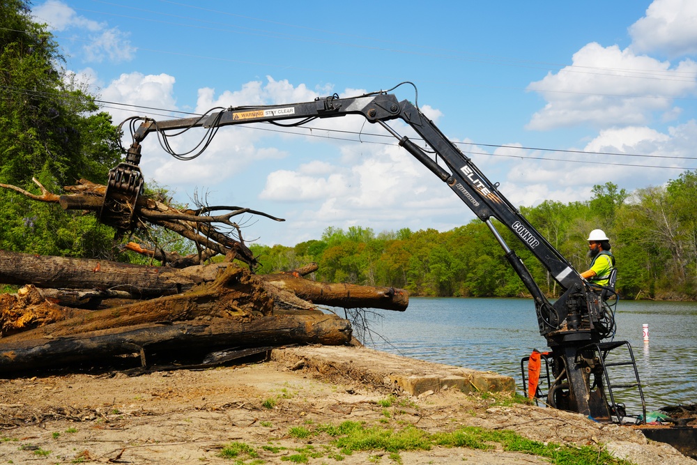 Contractors remove debris from Dutchmans Creek in Mount Holly as part of Hurricane Helene recovery efforts