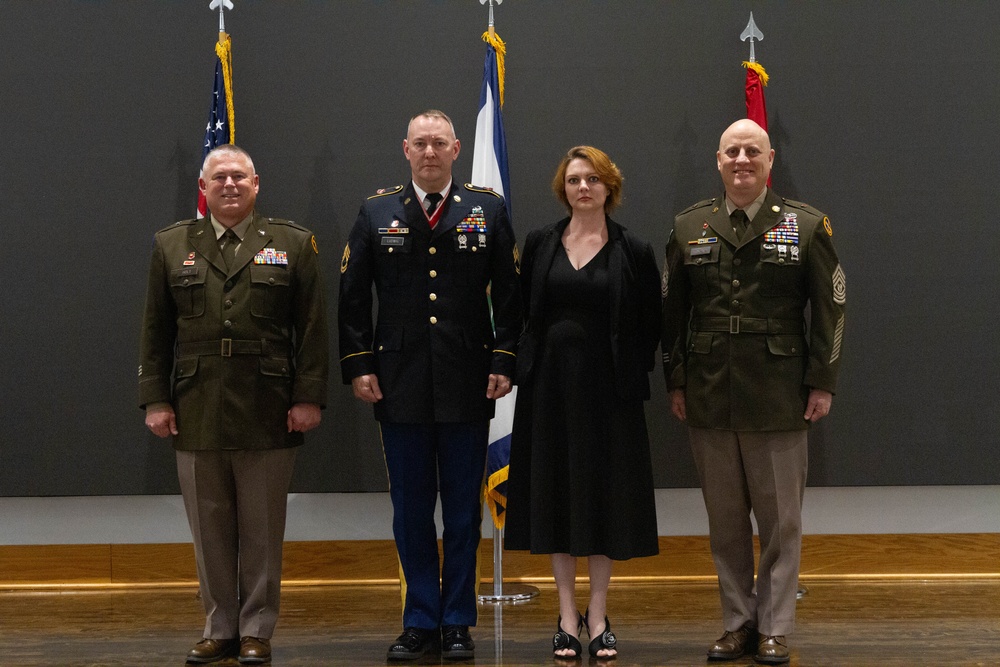 Sgt. 1st Class Chad Ludwig and his wife stand with Brig. Gen. Holt and Command Sgt. Maj. Kincaid.