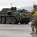 U.S. Soldiers move and ground guide Stryker combat vehicles to a motorpool