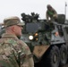 U.S. Soldiers move and ground guide Stryker combat vehicles to a motorpool
