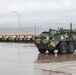 U.S. Soldiers move and ground guide Stryker combat vehicles to a motorpool