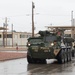 U.S. Soldiers move and ground guide Stryker combat vehicles to a motorpool