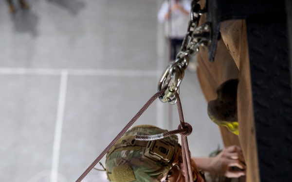 U.S. and Indian Soldiers climb rock wall during Tiger Triumph