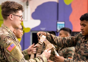 U.S. and Indian Soldiers climb rock wall during Tiger Triumph