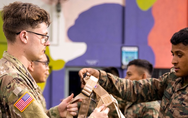 U.S. and Indian Soldiers climb rock wall during Tiger Triumph