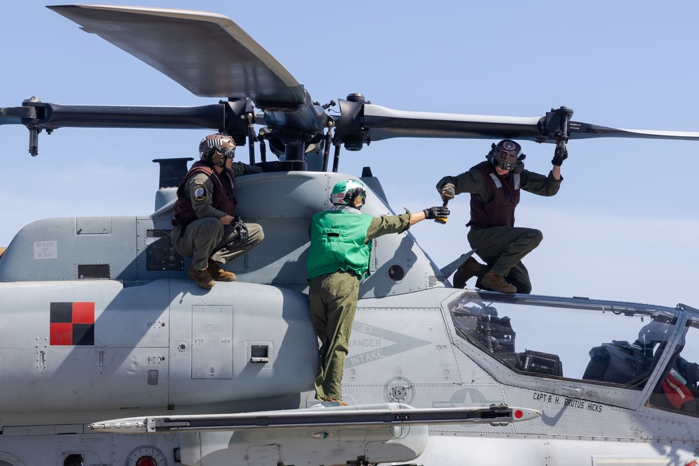 Marines onboard USS Iwo Jima secure AH-1W SuperCobra helicopter