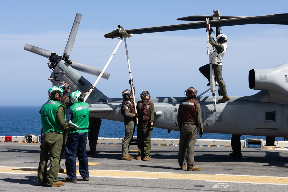 Marines onboard USS Iwo Jima secure AH-1W SuperCobra helicopter