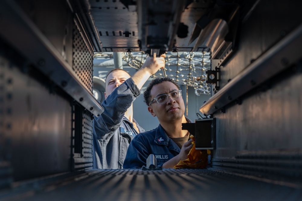 Fire Controlmen onboard USS Iwo Jima perform maintenance on NATO Sea Sparrow