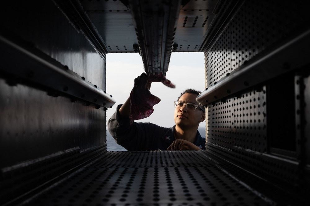 Fire Controlmen onboard USS Iwo Jima perform maintenance on NATO Sea Sparrow