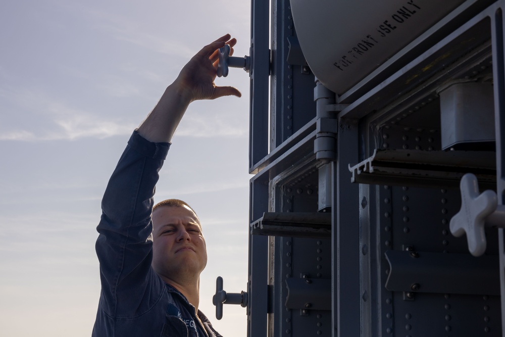 Fire Controlmen onboard USS Iwo Jima perform maintenance on NATO Sea Sparrow