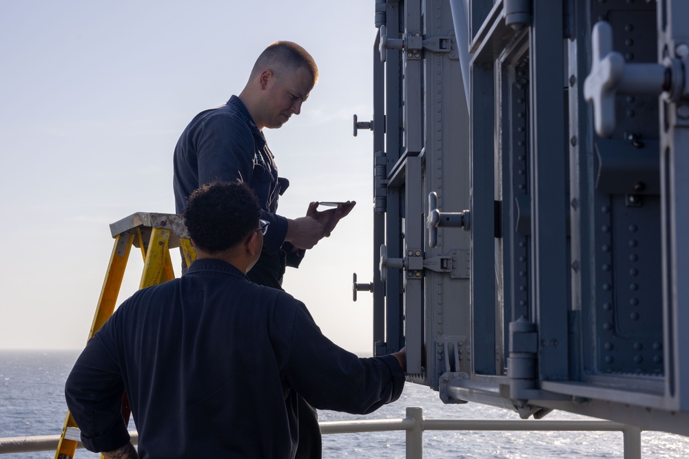 Fire Controlmen onboard USS Iwo Jima perform maintenance on NATO Sea Sparrow