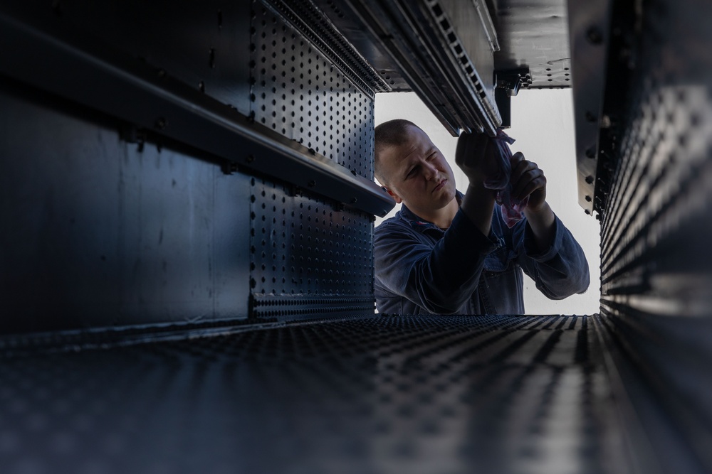 Fire Controlmen onboard USS Iwo Jima perform maintenance on NATO Sea Sparrow