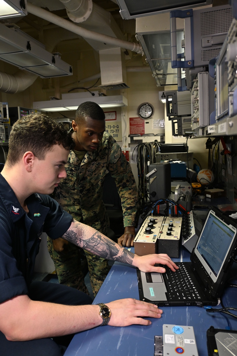 Sailor and Marines Calibrate Equipment On Board USS Iwo Jima
