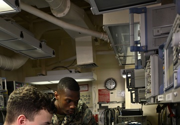 Sailor and Marines Calibrate Equipment On Board USS Iwo Jima