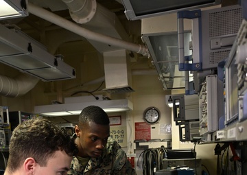 Sailor and Marines Calibrate Equipment On Board USS Iwo Jima