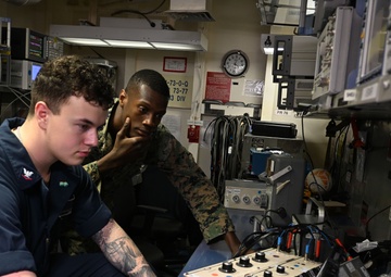 Sailor and Marines Calibrate Equipment On Board USS Iwo Jima