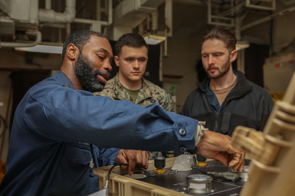 Sailors conduct training in USS Iwo Jima's PR shop